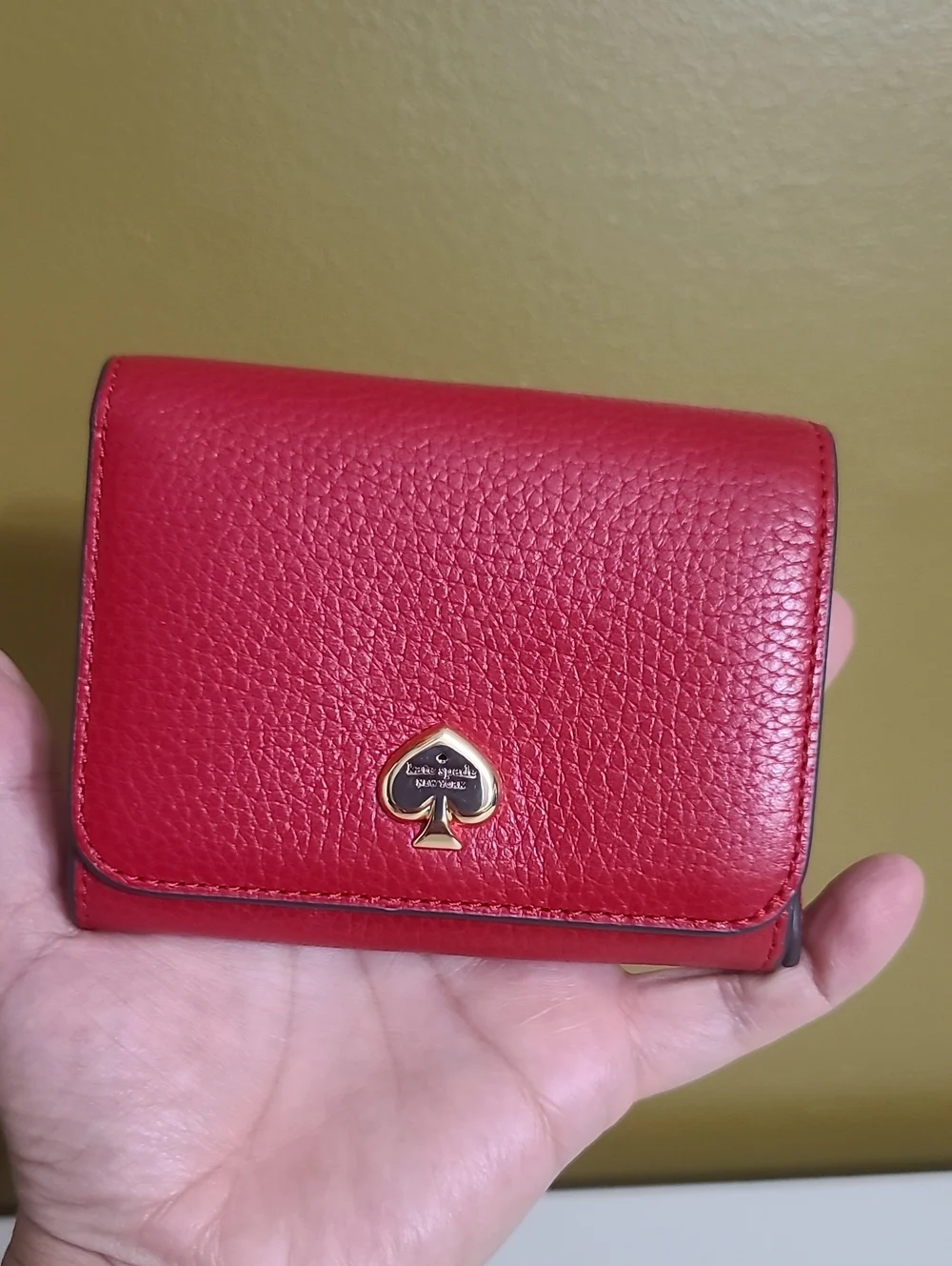 kate spade red pebbled leather trifold wallet with gold spade logo